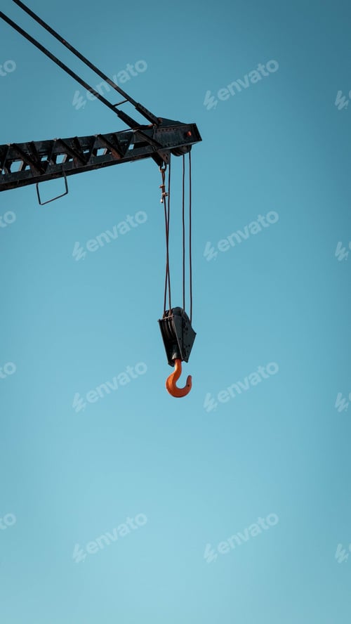 Preview: Industrial orange hook attached to a crane lifting equipment