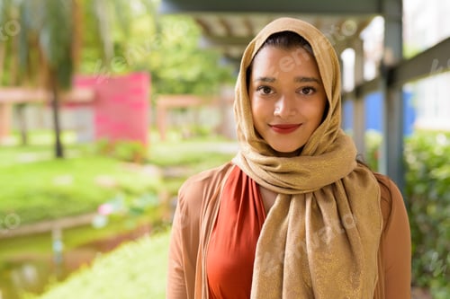 Preview: Face of young beautiful Indian Muslim woman at the park outdoors