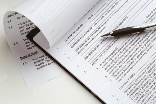 Preview: Contract document and pen on a desk during office hours for review and signing
