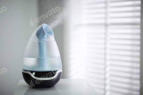 Preview: Modern air humidifier on table indoors. Space for text