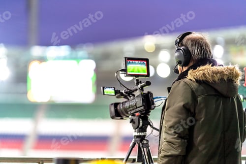 Preview: cameraman with a professional video camera on the broadcast of a football match