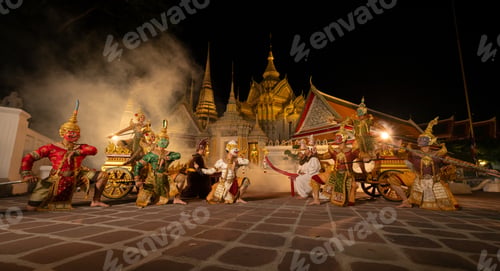 Preview: Traditional Thai masked dance performance at night in a historic temple courtyard