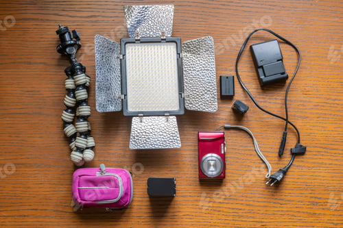 Preview: top view flat lay of blogger camera equipment on wooden surface