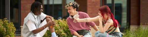 Preview: Multiethnic Group of Teenagers Laughing and Socializing Outdoors on Campus