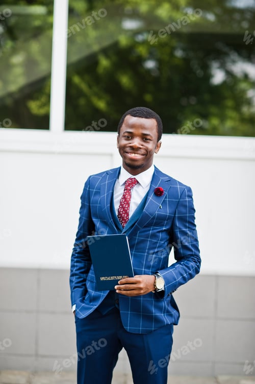Preview: African american happy successful man at suit with diploma at graduation day.