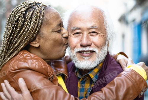 Preview: Happy multiracial senior couple having tender moments in city