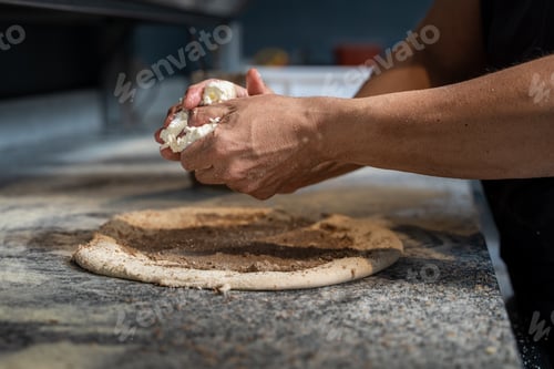 Preview: Professional pizza chef preparing dough with fresh mozzarella