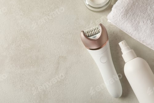Preview: Concept of skincare with epilator on white table