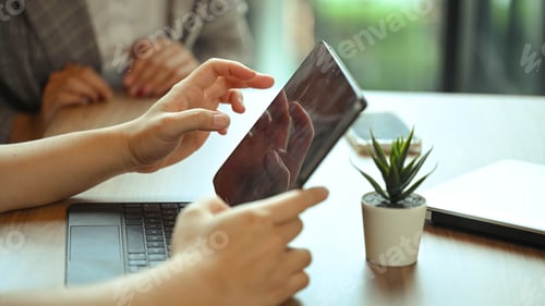 Preview: Businesspeople using digital tablet while collaborating on new project at co working space