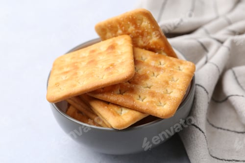 Preview: Tasty salty crackers on white table, closeup