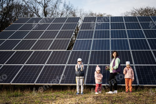 Preview: Mother with three kids on the background of solar panels. Eco energy.