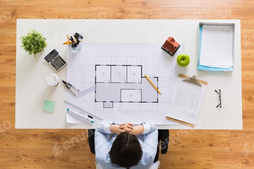 Preview: architect with house blueprint at office