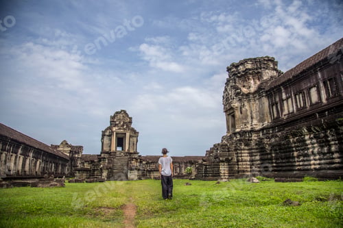 Preview: Woman in a white T-shirt walking through the temples of Angkor Wat, Cambodia