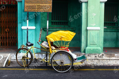Preview: Horizontal shot of a yellow cycle rickshaw in Georgetown, Malaysia