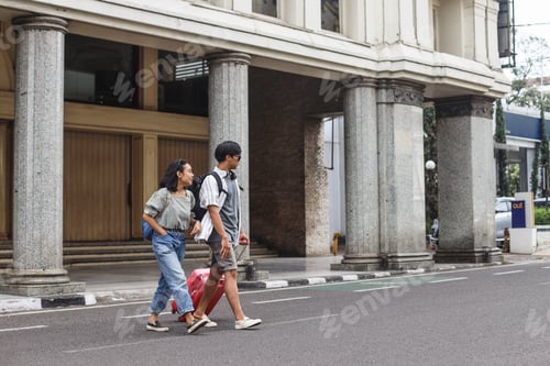 Preview: Couple traveller crossing the road