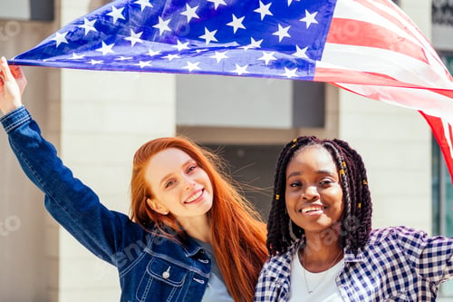Preview: latin hispanic and redhaired ginger women holding usa flag in the street
