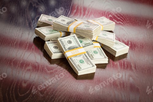 Preview: Thousands of Dollars with Reflection of American Flag on Table