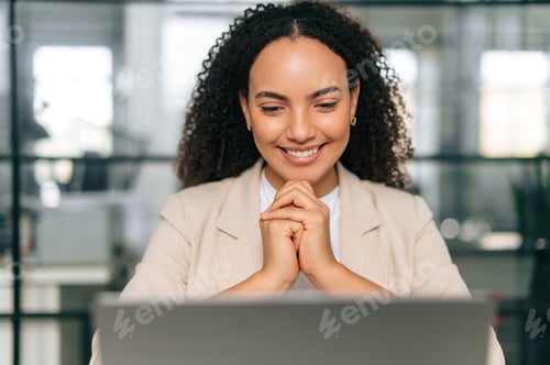 Preview: Satisfied brazilian or hispanic curly haired business woman, company ceo, recruitment manager, sits