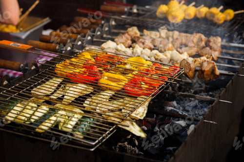 Preview: Delicious vegetables grilling on open grill, outdoor kitchen