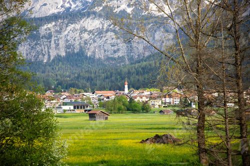 Preview: Beautilful green meadow and alpine village in spring, Austria