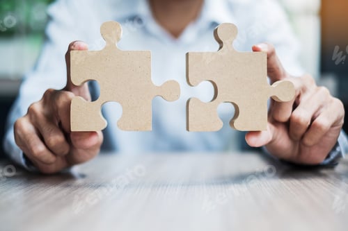 Preview: man hands connecting couple puzzle over table