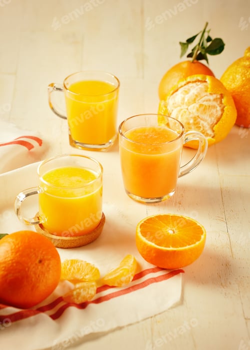 Preview: Vertical shot of fresh oranges and juice on a table