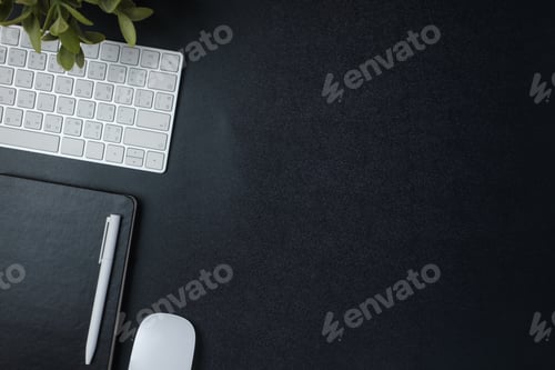 Preview: top view working desk with keyboard mouse and notebook on black table background