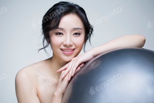 Preview: Beautiful young woman with fitness ball