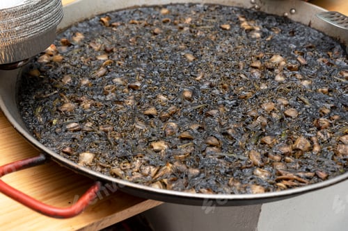 Preview: arroz negro, black rice, traditional Valencian dish similar to the seafood paella