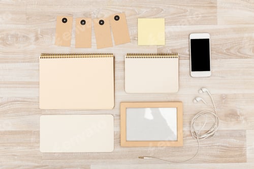 Preview: Stationery items and technology arranged on wooden surface in a creative workspace setting
