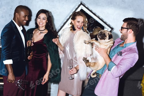 Preview: group of young friends on holiday party with little pug