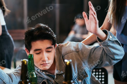 Preview: Asian sleepy man get drunk at the table in bar restaurant.