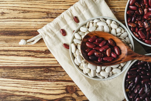 Preview: Assortment of beans on wooden background. Close up.
