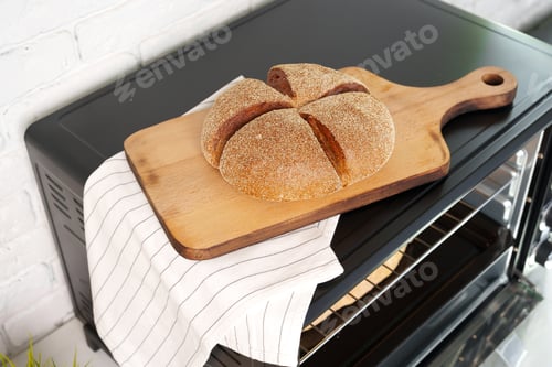 Preview: Freshly baked bread in mini oven in the kitchen