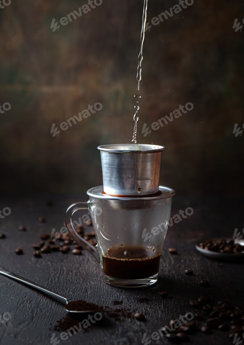 Preview: Preparation of Vietnamese coffe with vietnamese coffe filer on dark background