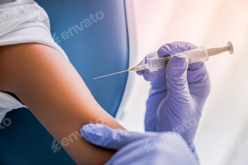 Preview: Close up of doctor's hand ready to injecting patient vaccine with syringe
