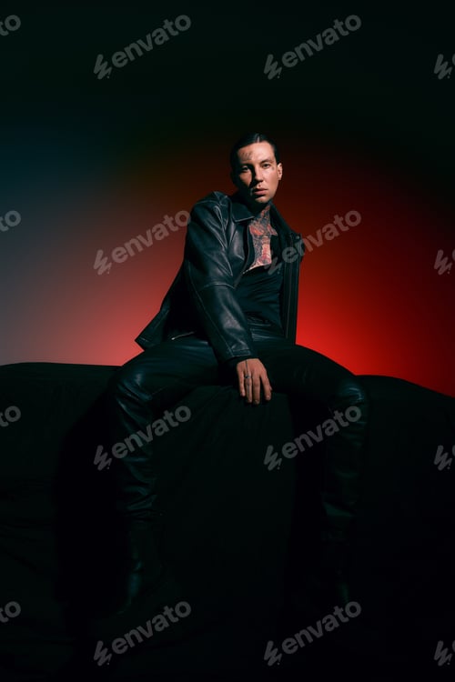 Preview: Stylish young man exudes confidence in a modern artistic setting with bold lighting
