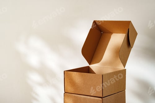Preview: Stacked Cardboard Boxes On Wooden Surface In Sunlight