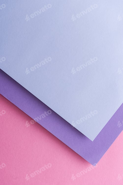 Preview: top view of blue and purple sheets of paper on pink background with copy space