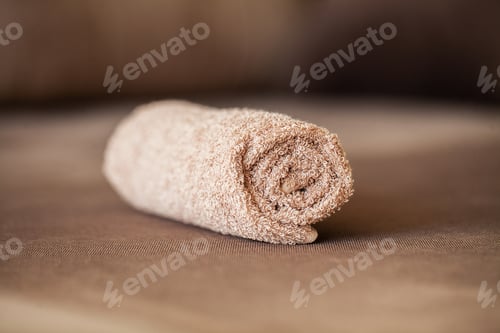 Preview: Towel on brown bed with copy space in living room.