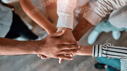 Preview: We are strong. Top view of business people holding hands together while standing in the office