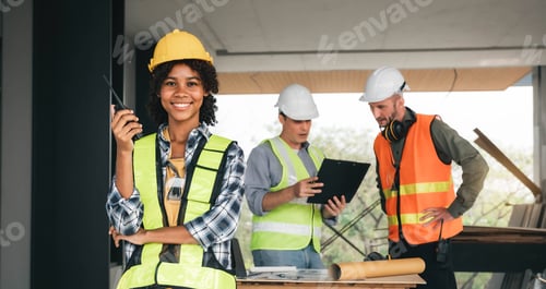 Preview: Leadership Concept by Female Engineers : Portrait of a happy female engineer in front of a group of