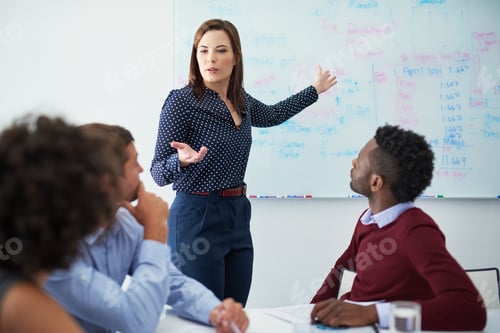 Preview: Cropped shot of a young businesswoman giving a presentation in the boardroom