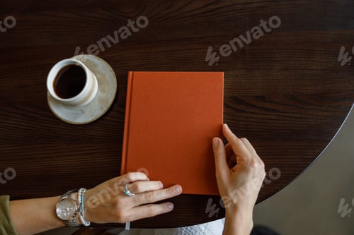 Preview: A cozy reading scene featuring a warm cup of coffee and a journal beautifully placed on the table