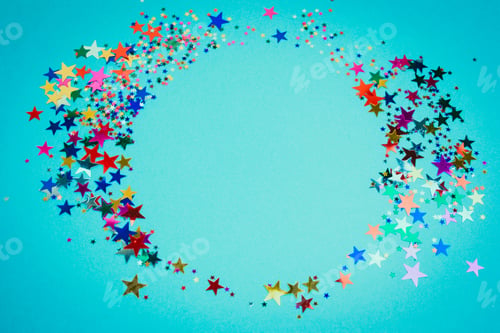 Preview: top view sequins shiny stars round frame on a blue background,vignette,mock up