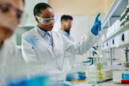 Preview: Black biotechnologist analyzing chemical samples during scientific research in a lab.