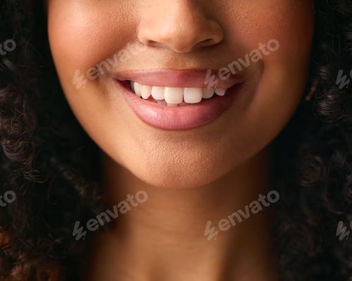 Preview: Close Up Studio Portrait Showing Mouth And Teeth Of Smiling Natural Woman