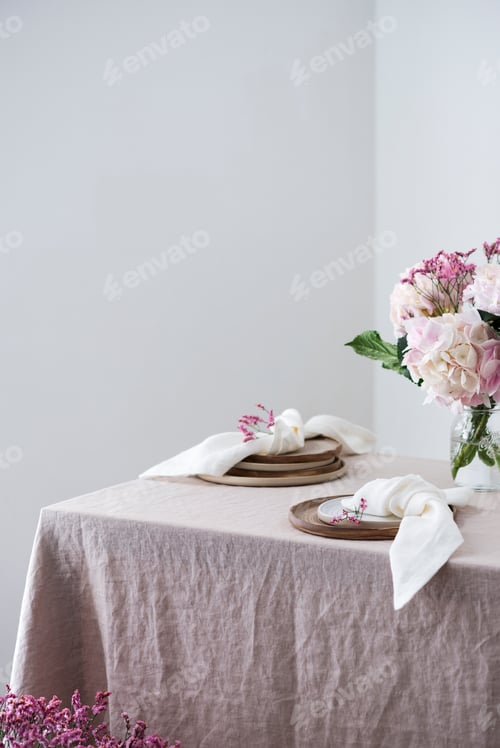 Elegant Table Setting with Flowers and Plates