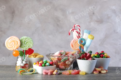 Preview: Candy bar. Many different sweets on wooden table against grey background. Space for text