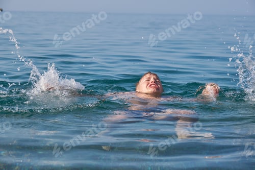 Preview: The child is drowning in the sea, screaming and waving his arms.